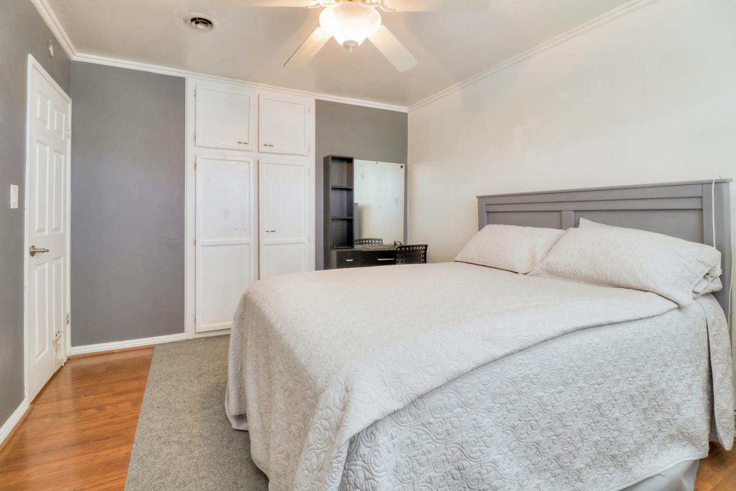 317 Tennyson Road Hayward, CA 94544 - Photo 14 of 21 a bedroom with a bed and a chandelier