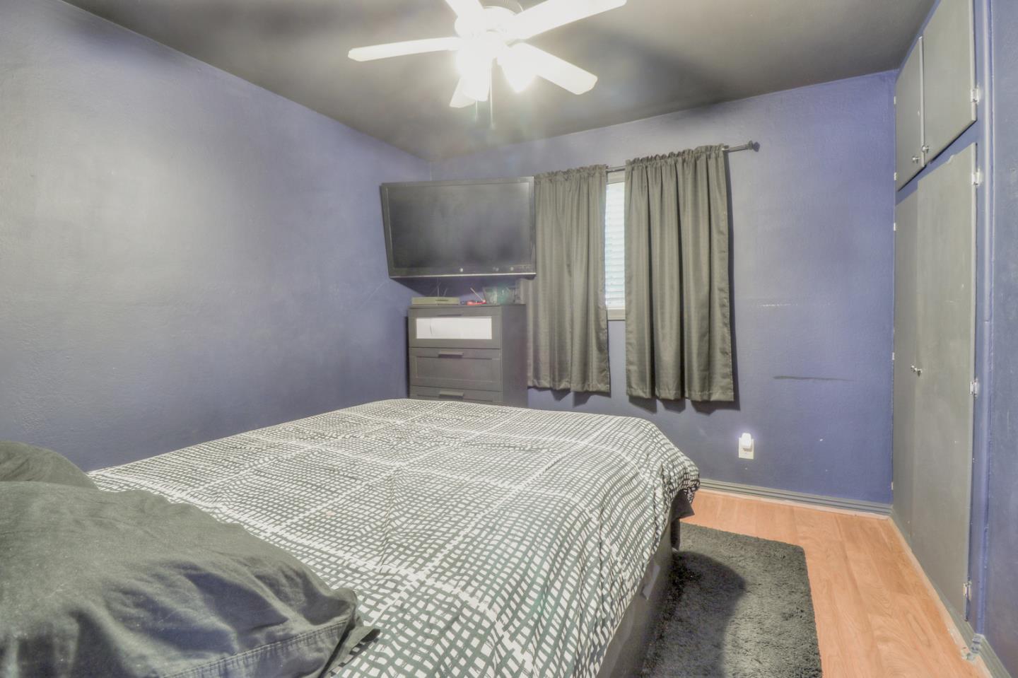 317 Tennyson Road Hayward, CA 94544 - Photo 17 of 21 a bedroom with a bed and a chandelier