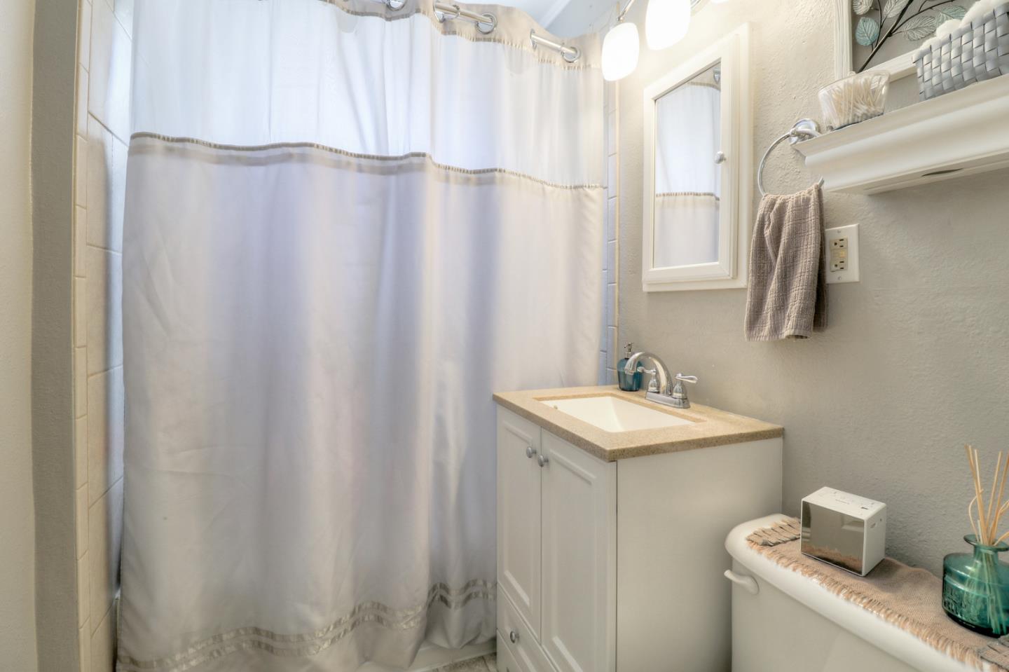 317 Tennyson Road Hayward, CA 94544 - Photo 18 of 21 a bathroom with a sink and a mirror