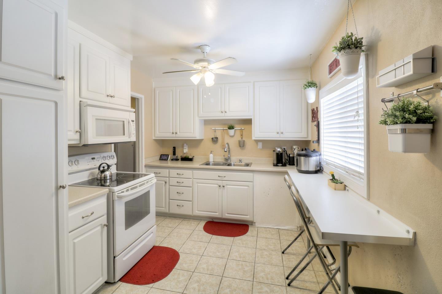 317 Tennyson Road Hayward, CA 94544 - Photo 6 of 21 a kitchen with white cabinets and appliances