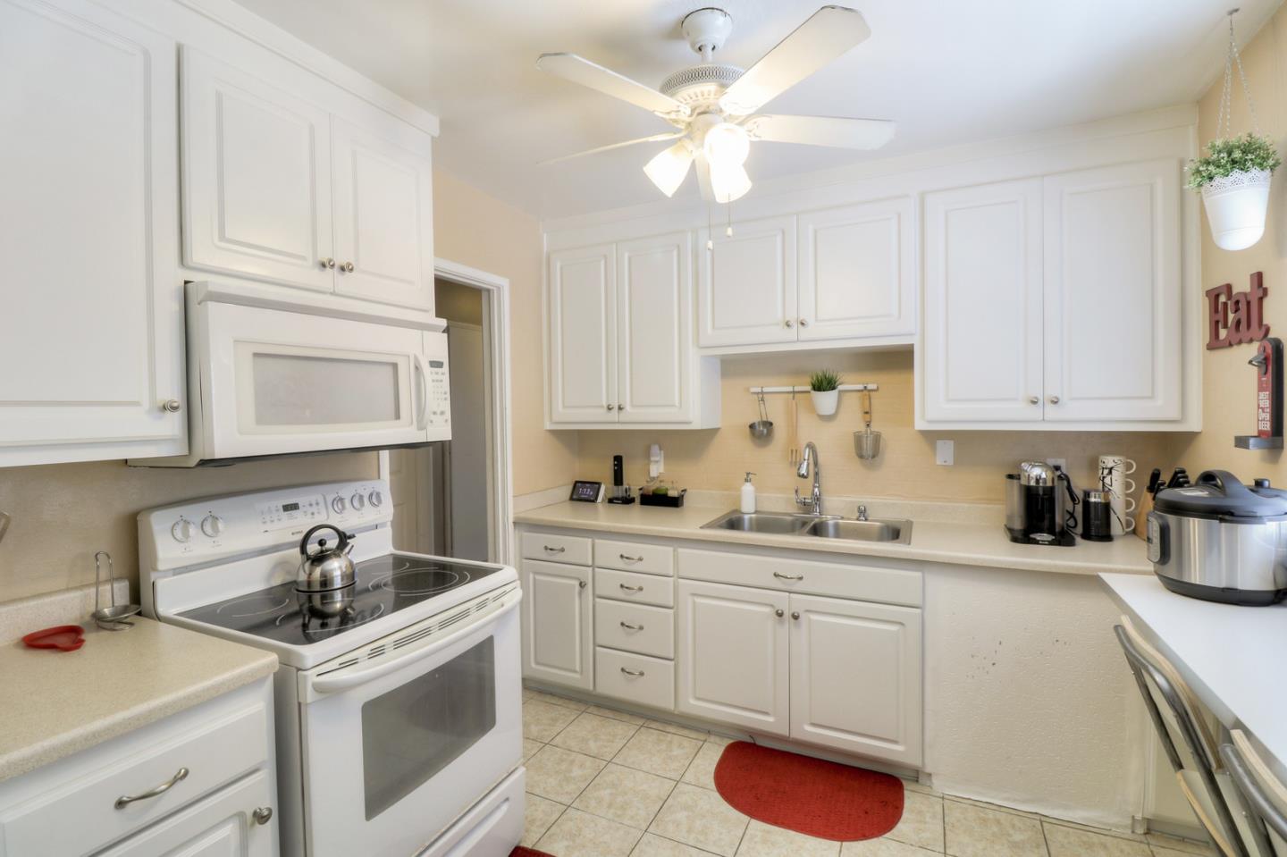 317 Tennyson Road Hayward, CA 94544 - Photo 7 of 21 a kitchen with white cabinets sink and white appliances