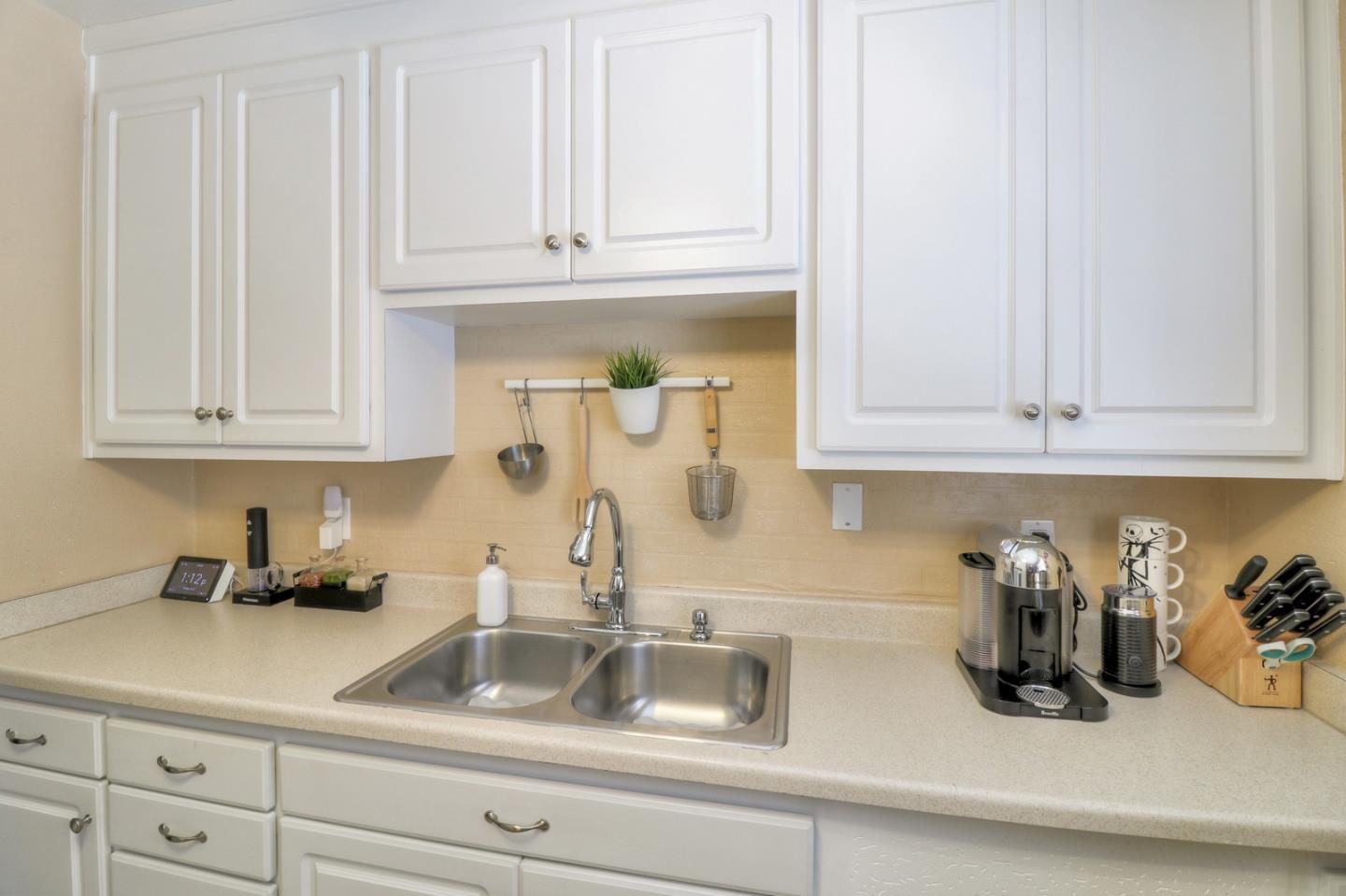 317 Tennyson Road Hayward, CA 94544 - Photo 8 of 21 a kitchen with white cabinets and a sink