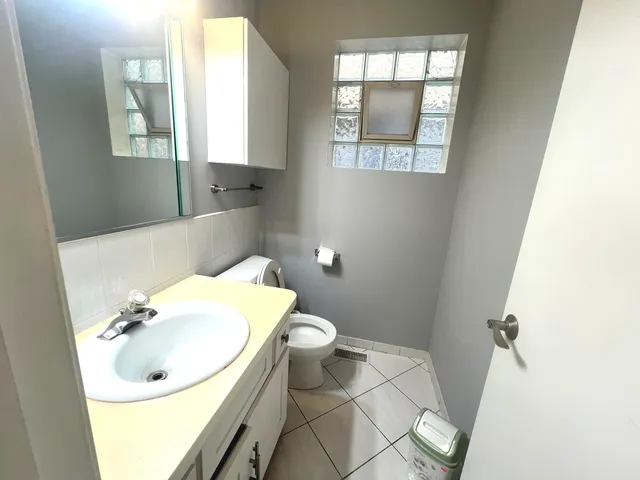 a bathroom with a sink toilet and mirror