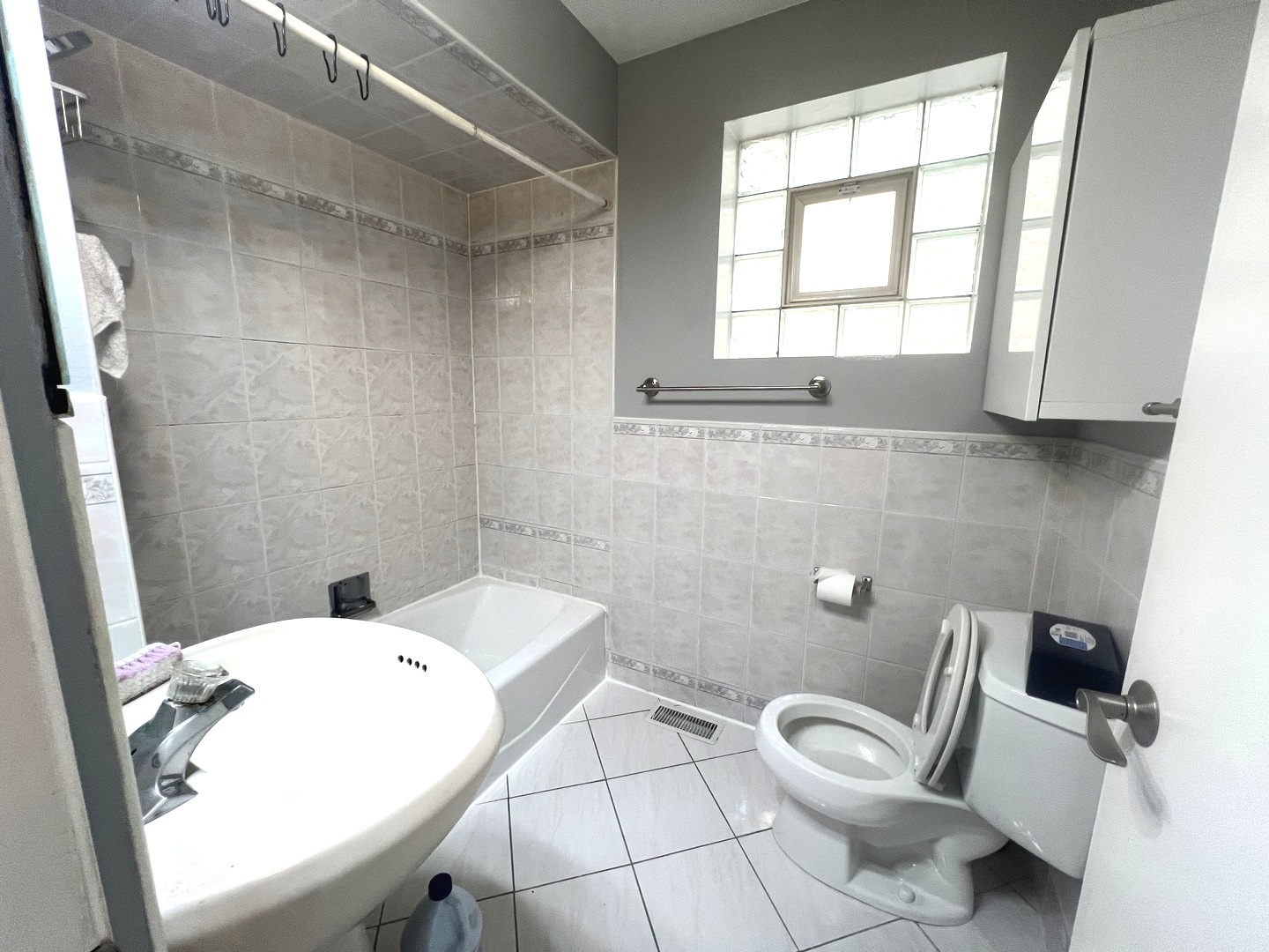 7445 West Belmont Avenue, Unit 1 Chicago, IL 60634 - Photo 12 of 20 a bathroom with a toilet sink and mirror