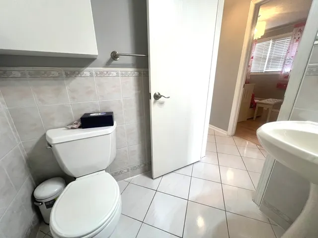 a white toilet sitting next to a bathroom sink