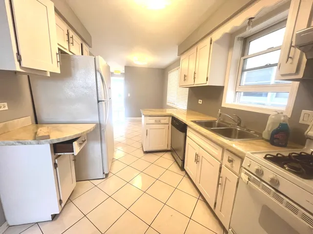 a kitchen with stainless steel appliances granite countertop a sink and a stove