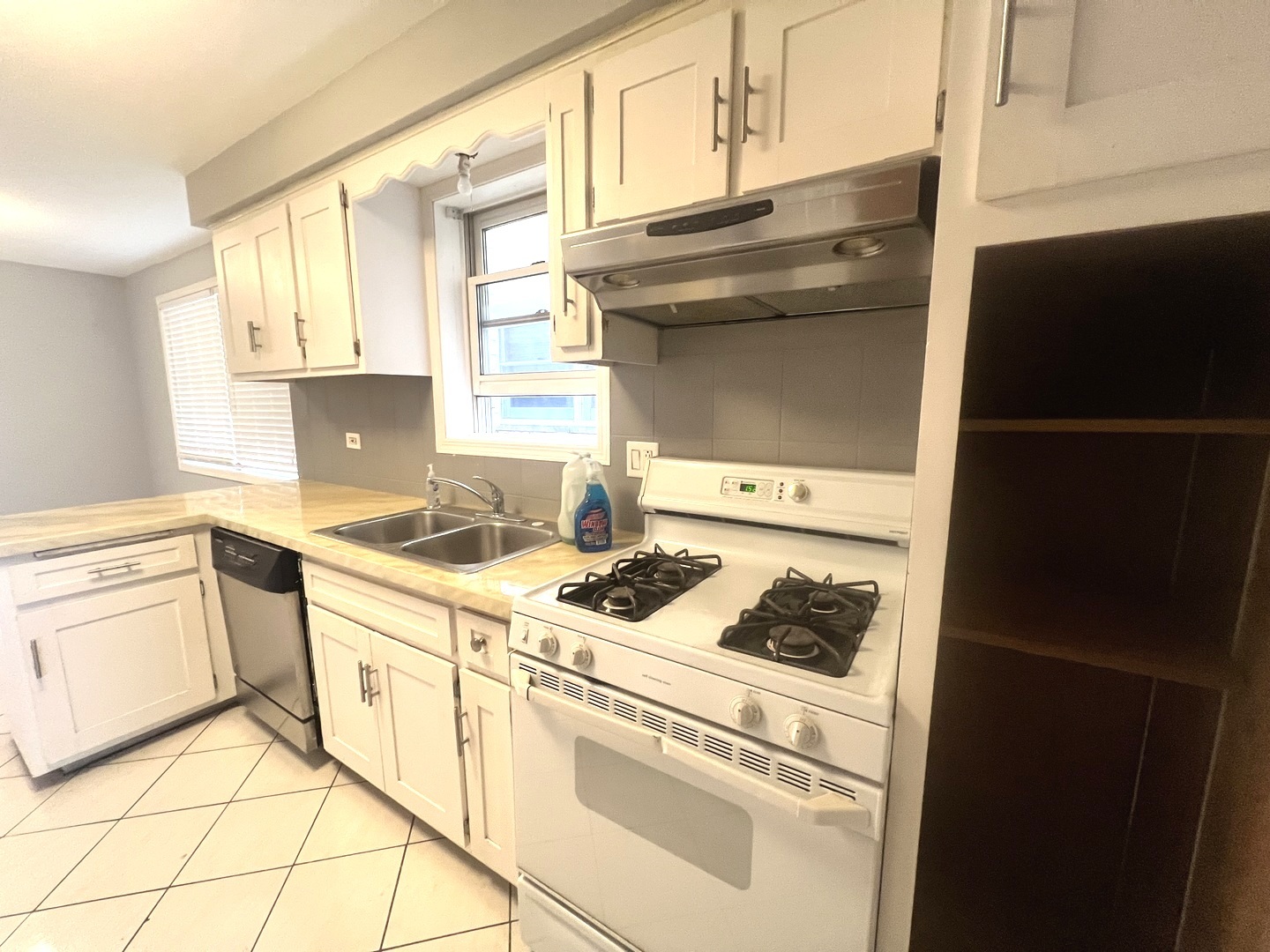 7445 West Belmont Avenue, Unit 1 Chicago, IL 60634 - Photo 15 of 20 a kitchen with granite countertop white cabinets and white appliances