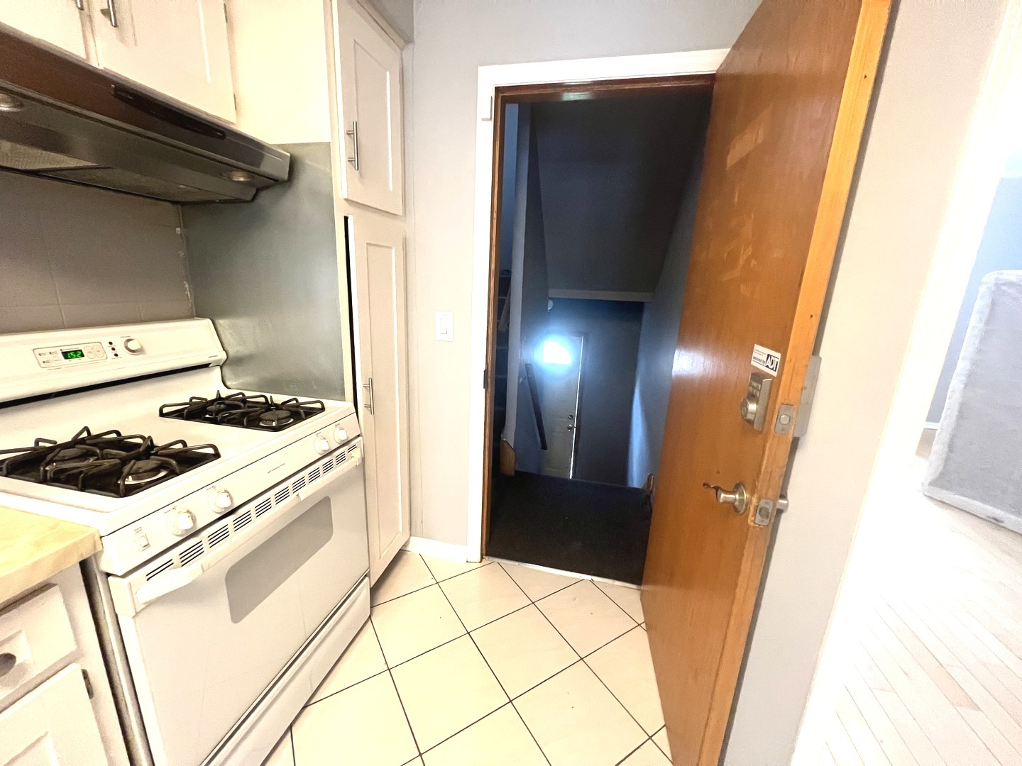 7445 West Belmont Avenue, Unit 1 Chicago, IL 60634 - Photo 17 of 20 a kitchen with a stove and white cabinets