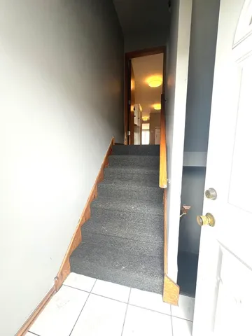 a view of entryway and hall with a front door