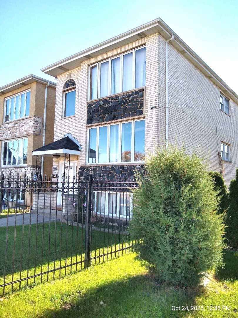 7445 West Belmont Avenue, Unit 1 Chicago, IL 60634 - Photo 2 of 20 a front view of a house with a yard