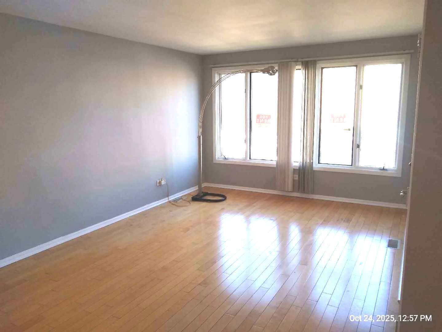 7445 West Belmont Avenue, Unit 1 Chicago, IL 60634 - Photo 6 of 20 an empty room with wooden floor and windows
