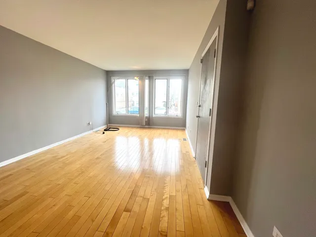 wooden floor in a room next to a window