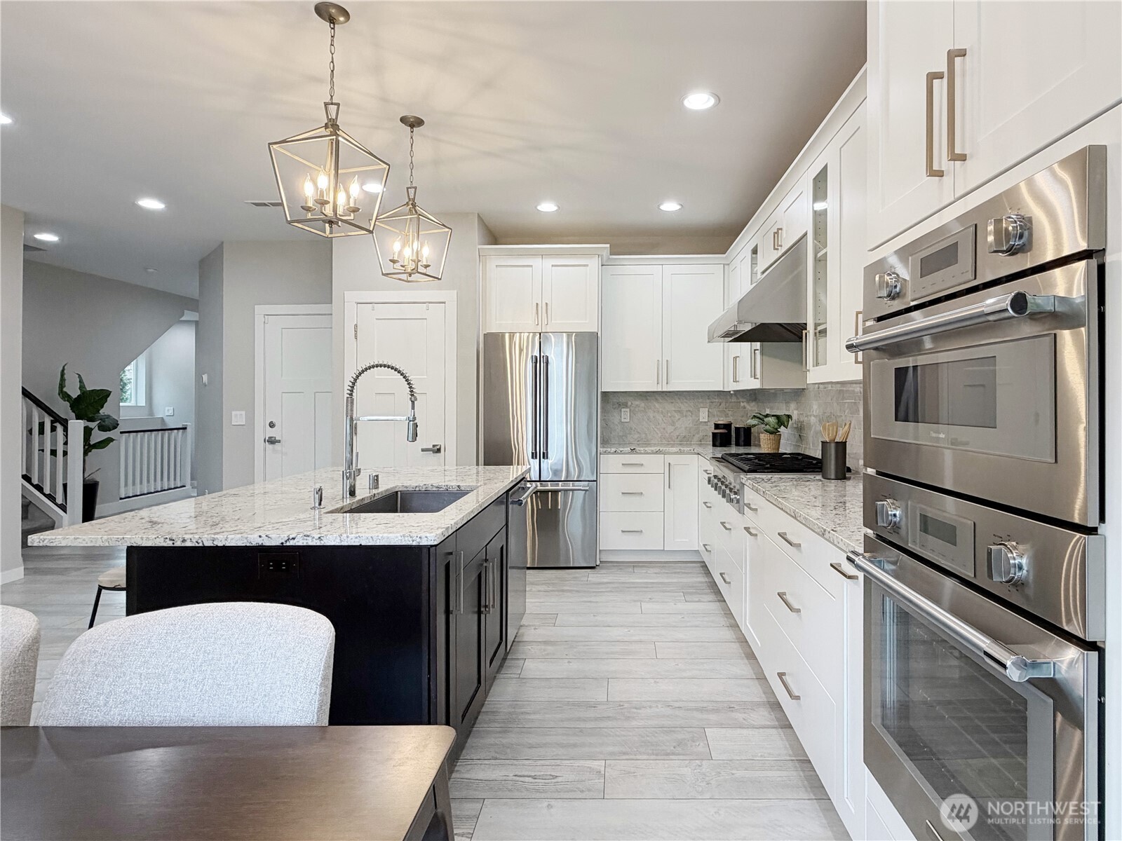22724 41st Drive Southeast Bothell, WA 98021 - Photo 14 of 40 a large kitchen with stainless steel appliances kitchen island granite countertop a sink and cabinets