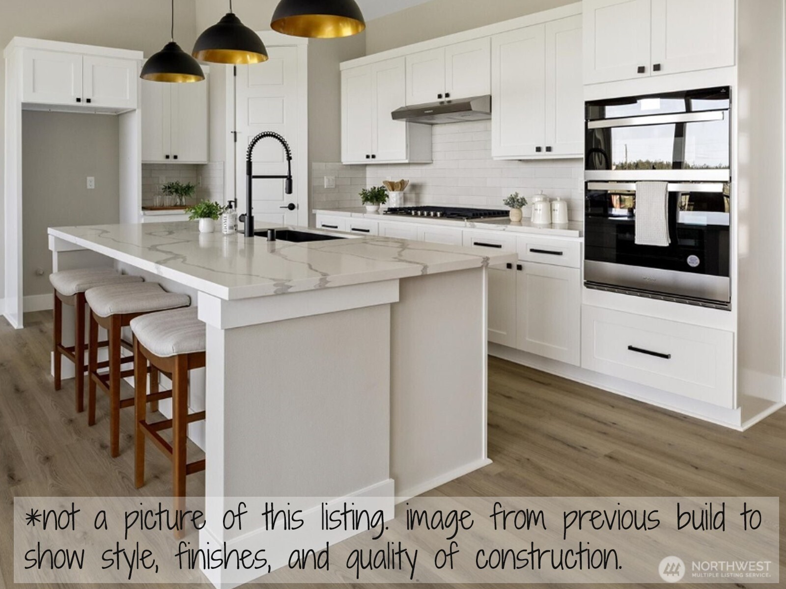 1780 Twin Oaks Lane Freeland, WA 98249 - Photo 7 of 8 a kitchen with stainless steel appliances granite countertop a stove a sink and a microwave