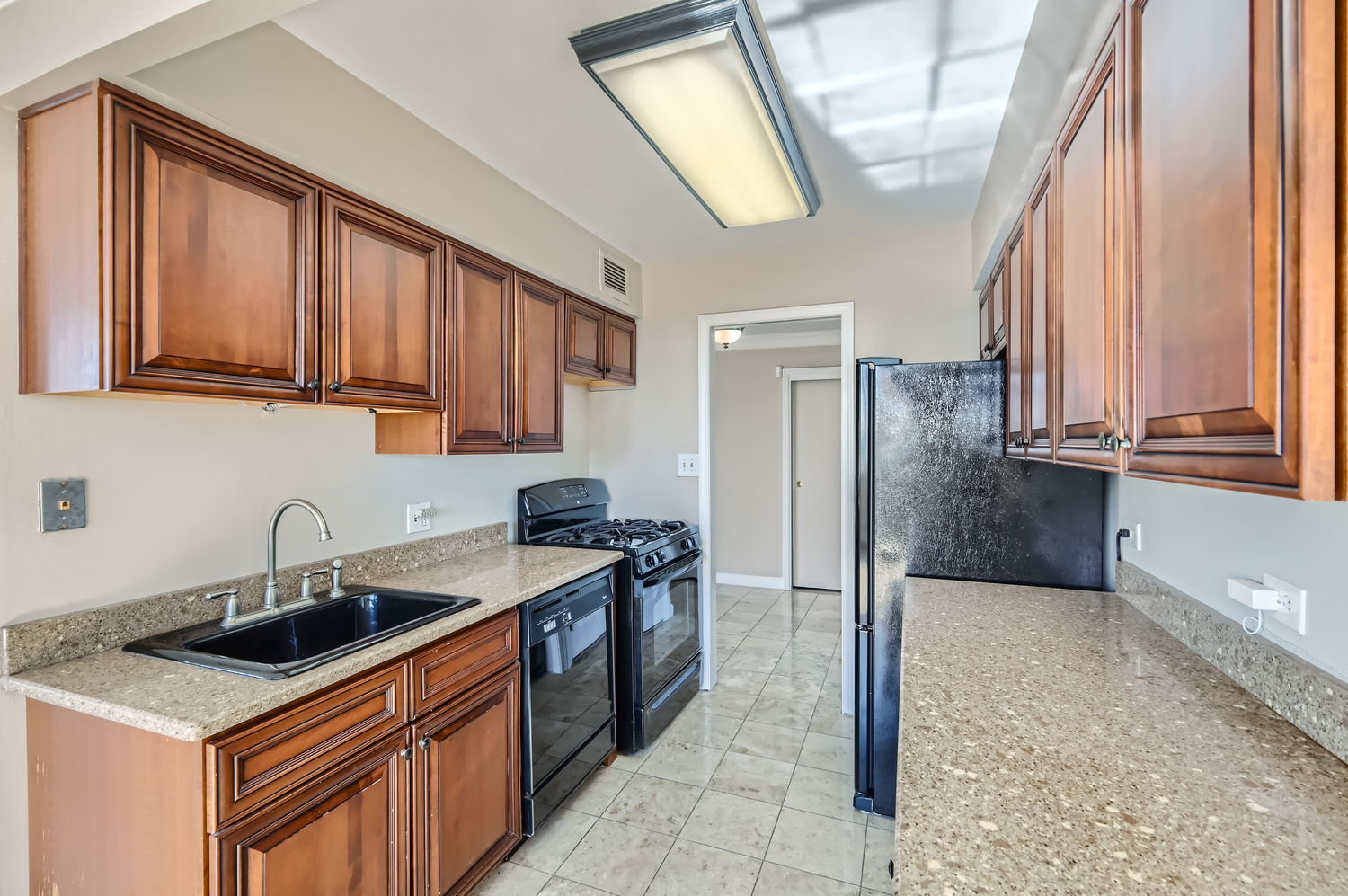 20 North Tower Road, Unit 12M Oak Brook, IL 60523 - Photo 12 of 28 a kitchen that has a sink a stove and a refrigerator