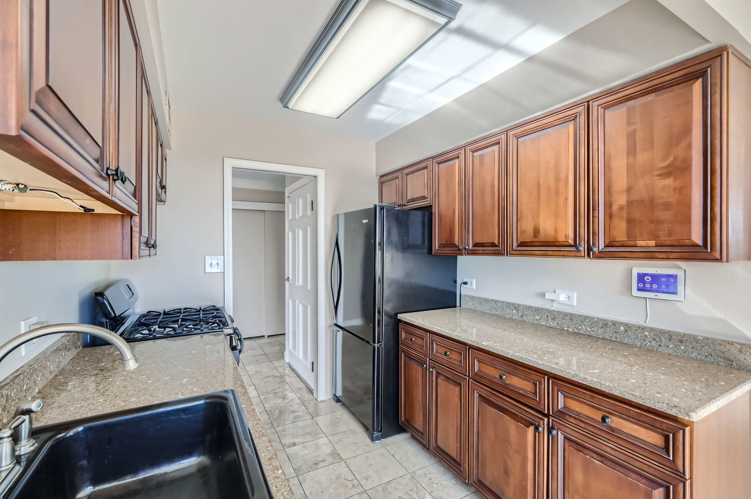 20 North Tower Road, Unit 12M Oak Brook, IL 60523 - Photo 13 of 28 a kitchen with granite countertop a sink stainless steel appliances and cabinets