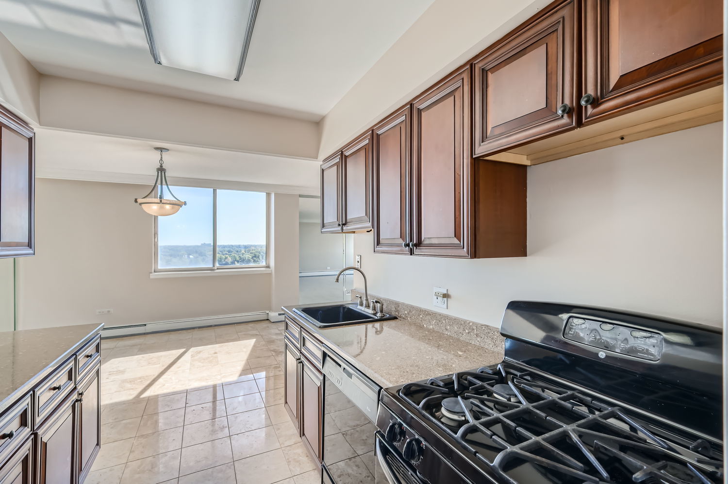 20 North Tower Road, Unit 12M Oak Brook, IL 60523 - Photo 14 of 28 a kitchen with a sink stove and cabinets