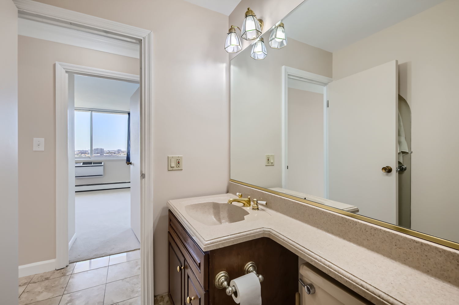 20 North Tower Road, Unit 12M Oak Brook, IL 60523 - Photo 22 of 28 a bathroom with a sink a light fixture and a mirror