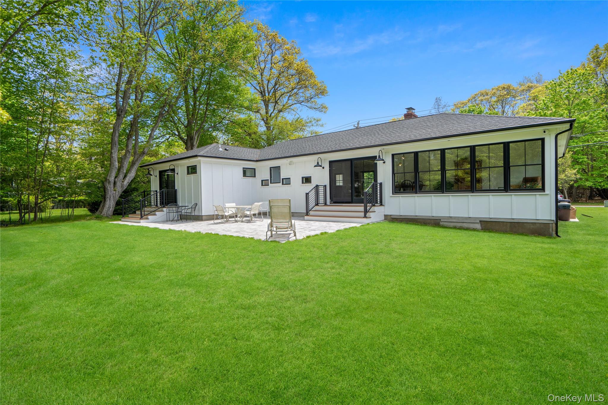 263 Beaver Dam Road Brookhaven, NY 11719 - Photo 27 of 32 a front view of house with a garden and patio