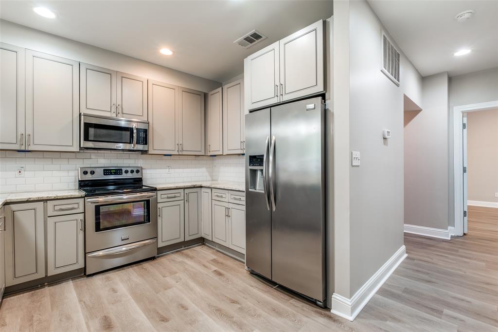 3912 Rawlins Street, Unit 2 Dallas, TX 75219 - Photo 13 of 25 a kitchen with stainless steel appliances cabinets a sink and a center island