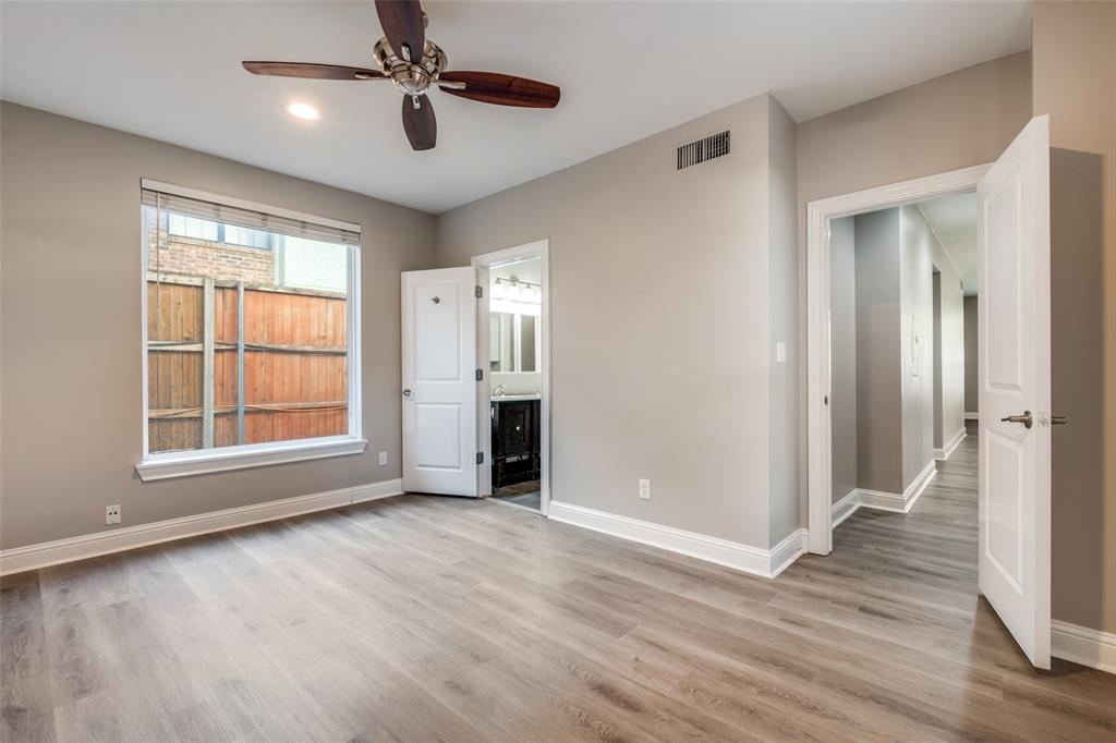 3912 Rawlins Street, Unit 2 Dallas, TX 75219 - Photo 17 of 25 a view of an empty room with wooden floor and a window