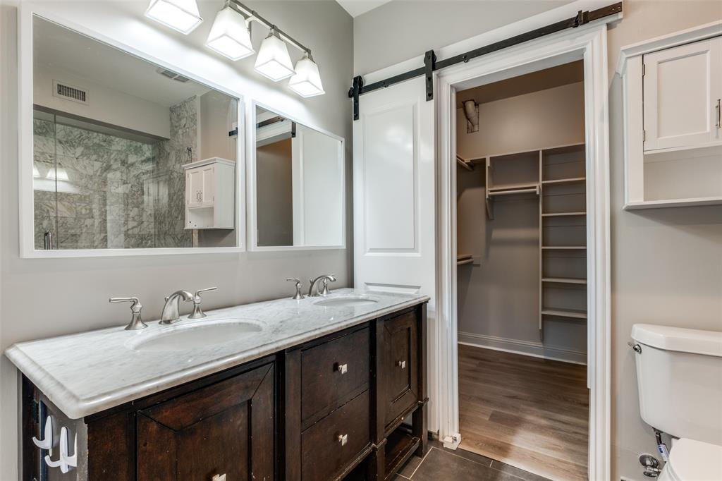 3912 Rawlins Street, Unit 2 Dallas, TX 75219 - Photo 18 of 25 a bathroom with a sink double vanity and a mirror