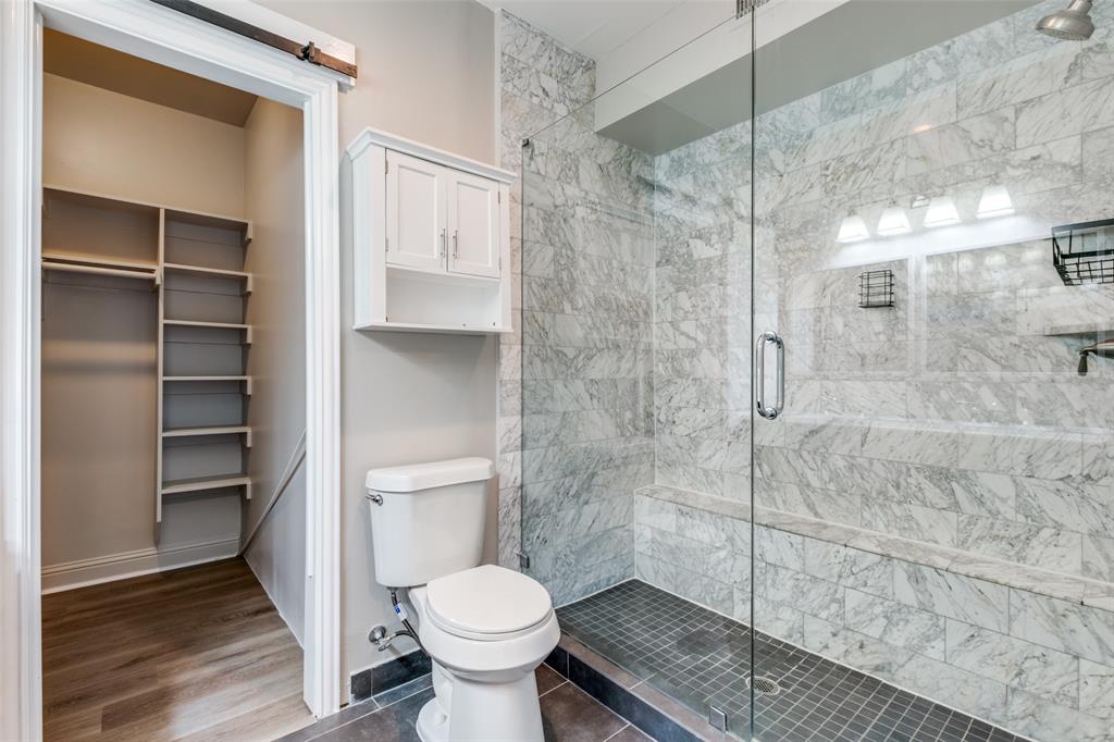 3912 Rawlins Street, Unit 2 Dallas, TX 75219 - Photo 19 of 25 a bathroom with a toilet and a shower