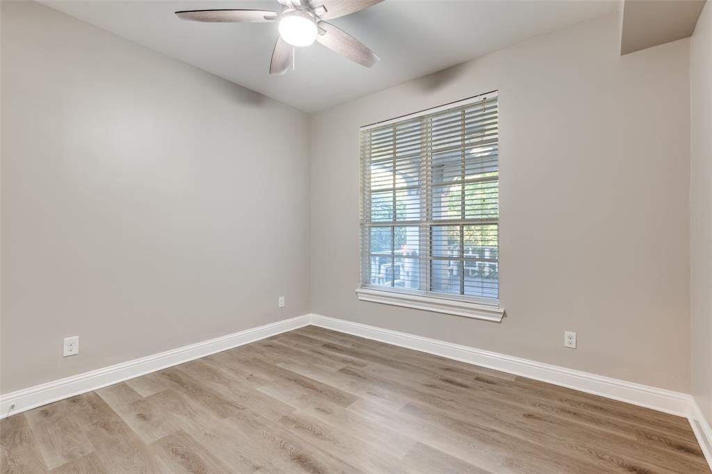 3912 Rawlins Street, Unit 2 Dallas, TX 75219 - Photo 22 of 25 an empty room with wooden floor and windows