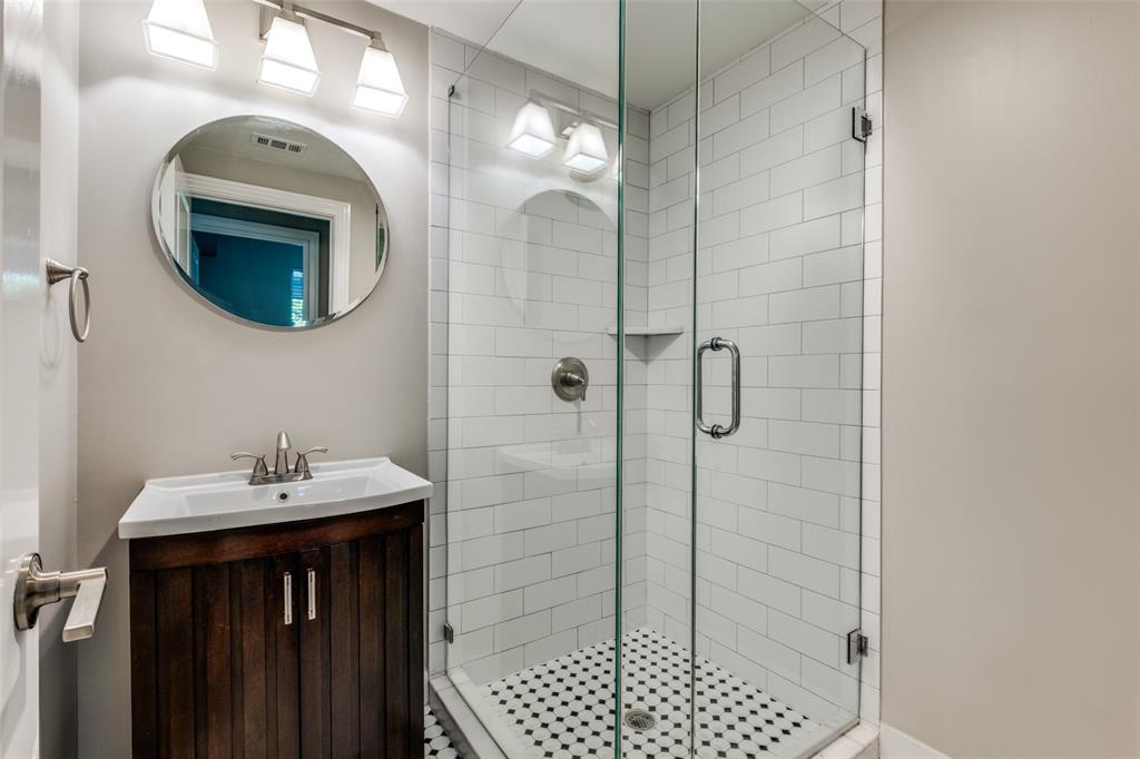 3912 Rawlins Street, Unit 2 Dallas, TX 75219 - Photo 23 of 25 a bathroom with a sink a shower and a mirror