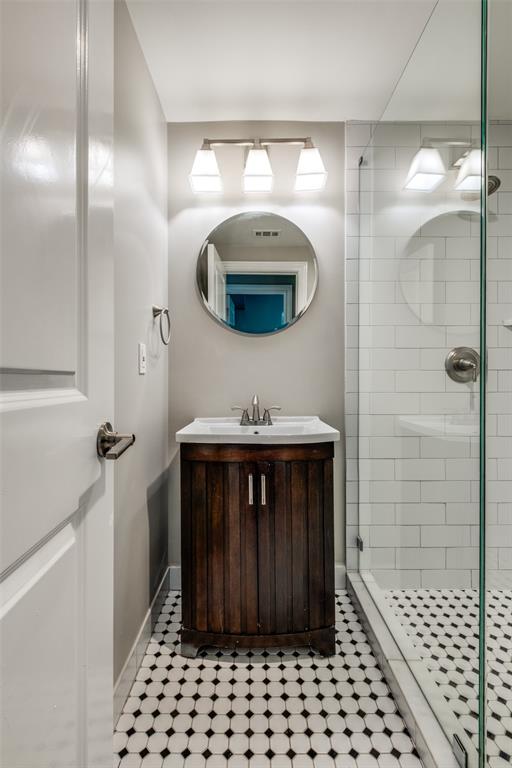 3912 Rawlins Street, Unit 2 Dallas, TX 75219 - Photo 24 of 25 a bathroom with a sink and a mirror