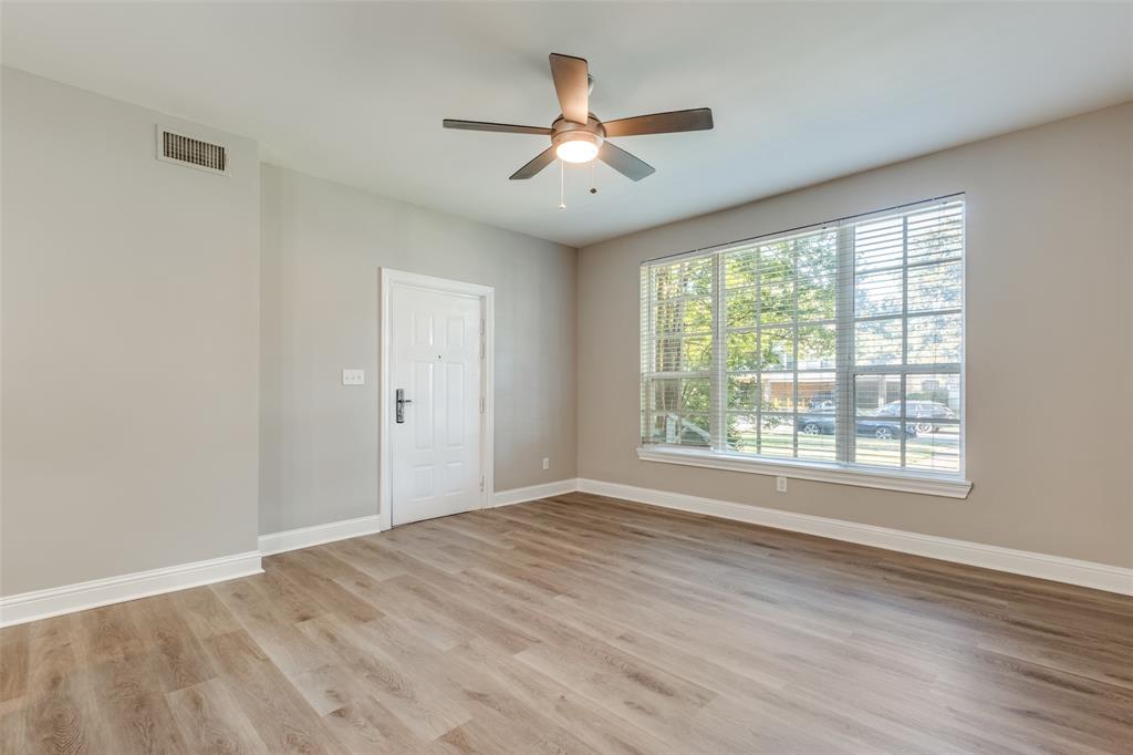 3912 Rawlins Street, Unit 2 Dallas, TX 75219 - Photo 3 of 25 a view of an empty room with wooden floor and a window
