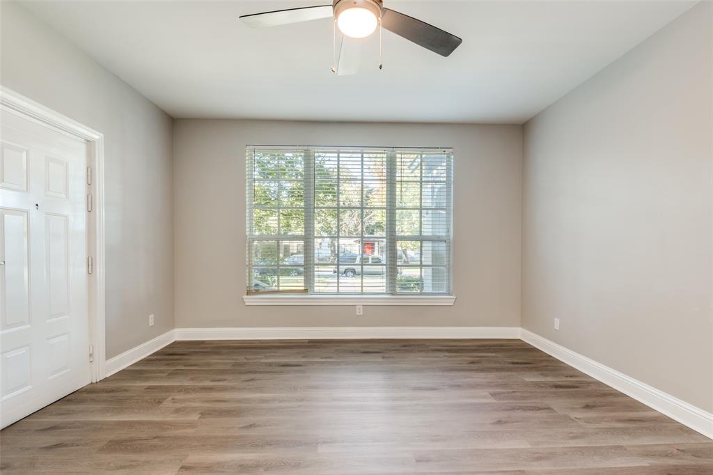 3912 Rawlins Street, Unit 2 Dallas, TX 75219 - Photo 4 of 25 an empty room with wooden floor and windows