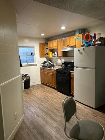 a kitchen with stainless steel appliances granite countertop a refrigerator sink and stove