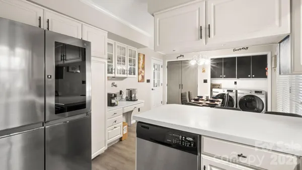 a kitchen with stainless steel appliances a stove refrigerator and a sink