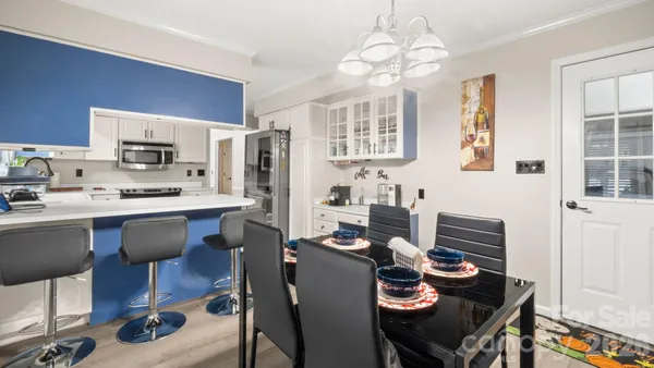 a kitchen with a refrigerator and a stove top oven
