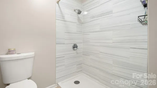 a bathroom with a shower and a toilet