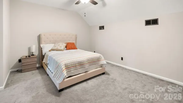 a bedroom with a bed and a night stand