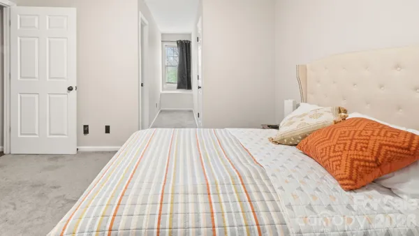 a bedroom with a bed and a lamp