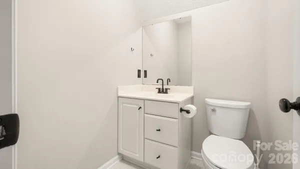 a bathroom with a toilet a sink and mirror
