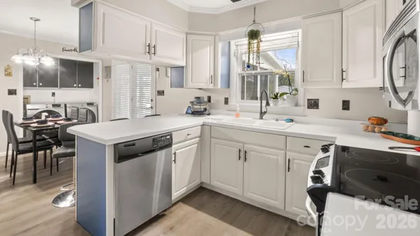 a kitchen with a sink stove and cabinets