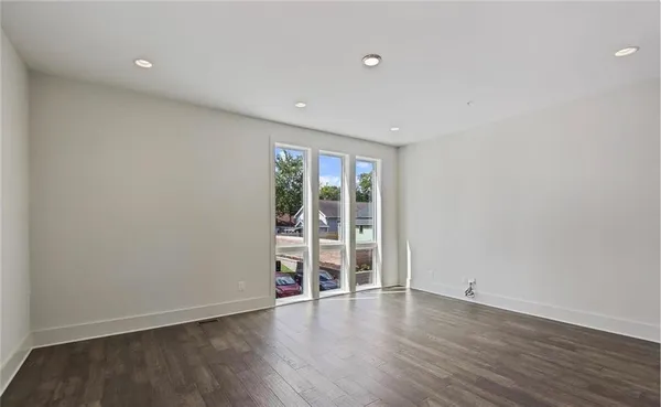 a view of a room with wooden floor and white walls