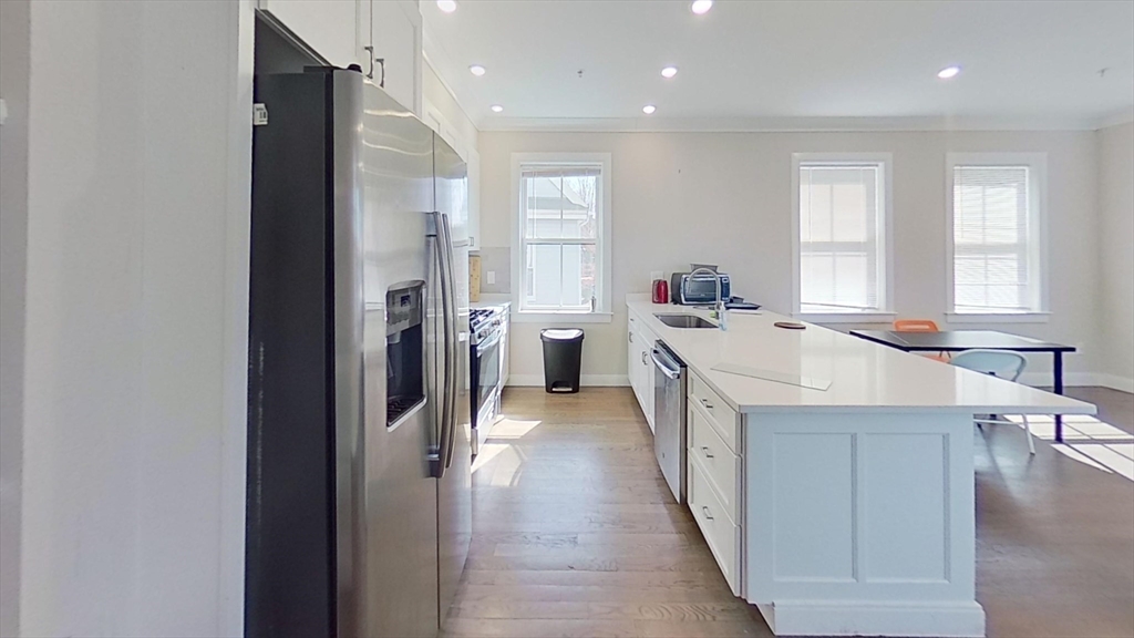 a kitchen with a sink stove and refrigerator