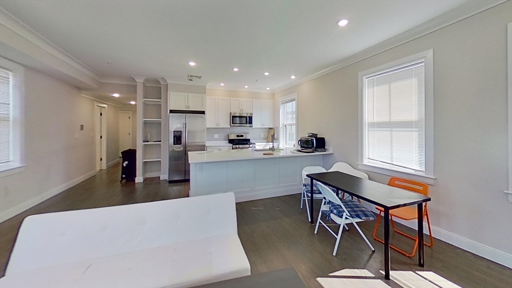 79 Linden Street, Unit 3 Boston, MA 02134 - Photo 2 of 9 a living room with stainless steel appliances kitchen island granite countertop furniture and a window