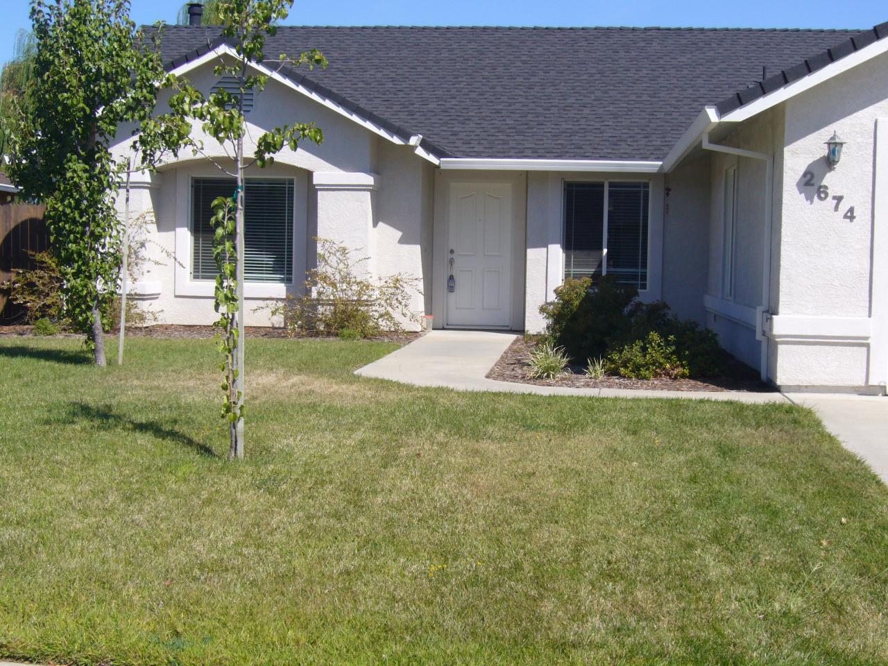 2674 Rhinestone Way Redding, CA 96001 - Photo 1 of 7 a front view of a house with a yard