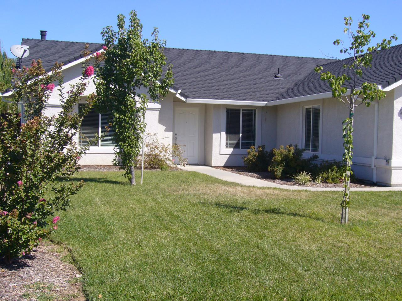 2674 Rhinestone Way Redding, CA 96001 - Photo 7 of 7 a front view of a house with a yard and a garage