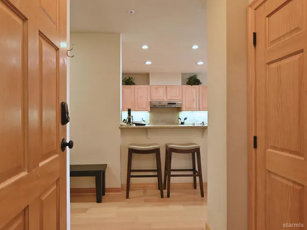 a kitchen with kitchen island a sink stainless steel appliances and cabinets
