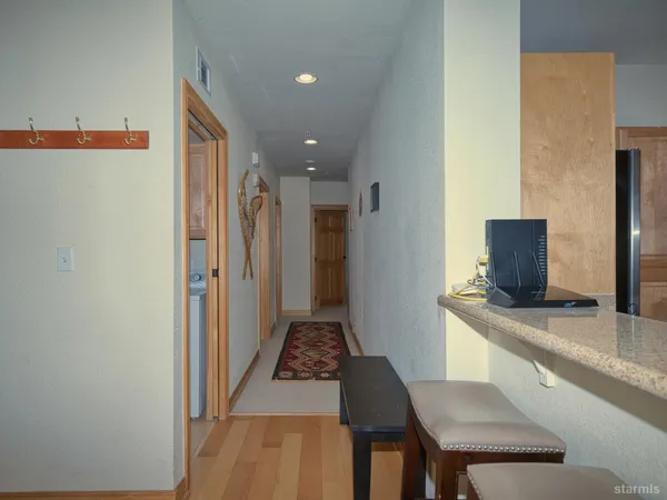 a hallway with a table and chairs