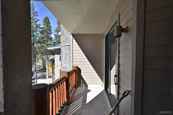 a view of balcony with wooden floor and stairs