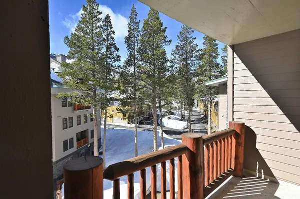 a view of a balcony with mountain view and wooden floor