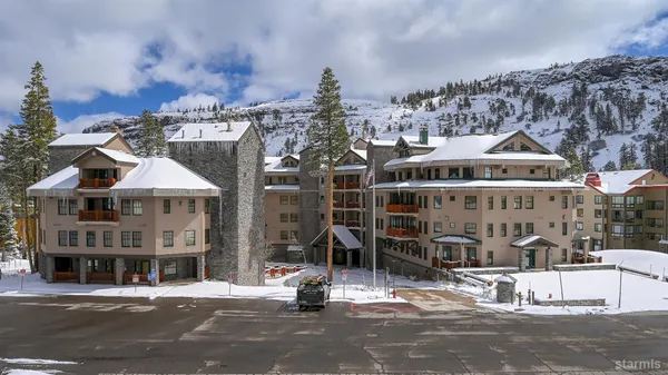 a front view of a building with parking spaces